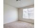 Bright bedroom with a window letting in natural light and neutral carpet flooring at 4542 Townwall St, Las Vegas, NV 89115