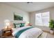 Serene bedroom showcasing a comfortable bed, soft lighting, and a relaxing ambiance with natural light from the window at 4542 Townwall St, Las Vegas, NV 89115