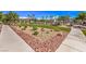 An inviting common area with lush landscaping, including rocks, plants, and a covered picnic area at 4542 Townwall St, Las Vegas, NV 89115