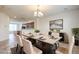 Inviting dining area with a stylish table set, chandelier lighting, and neutral decor for elegant meals at 4542 Townwall St, Las Vegas, NV 89115