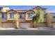 Attractive townhomes featuring attached garages and neutral-colored exteriors in a well-maintained neighborhood at 4542 Townwall St, Las Vegas, NV 89115