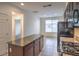 Modern kitchen features stainless steel appliances, granite countertops, and a functional kitchen island at 4542 Townwall St, Las Vegas, NV 89115