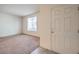 A bright living room with neutral carpet and a large window providing natural light at 4542 Townwall St, Las Vegas, NV 89115