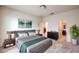 Well-lit bedroom featuring a cozy bed, contemporary furnishings, and an open doorway leading to a closet at 4542 Townwall St, Las Vegas, NV 89115