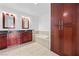 Bathroom featuring a double vanity, soaking tub, and dark wood cabinets at 4575 Dean Martin Dr # 3009, Las Vegas, NV 89103