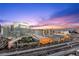 Breathtaking city view featuring high-rise buildings and highway traffic under a vibrant sky at sunset at 4575 Dean Martin Dr # 3009, Las Vegas, NV 89103