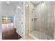 Shower featuring frameless glass doors, tile walls, and dark wood flooring at 4575 Dean Martin Dr # 3009, Las Vegas, NV 89103