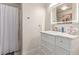 Bathroom with marble top vanity, decorative hardware, a large, lighted mirror, and a shower at 4786 Valleyside Ave, Las Vegas, NV 89115