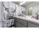 Bathroom featuring a single sink vanity, a mirror, and a decorative shower curtain at 4786 Valleyside Ave, Las Vegas, NV 89115