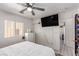 Bright bedroom featuring a ceiling fan, window, and a large TV mounted on the wall at 4786 Valleyside Ave, Las Vegas, NV 89115