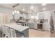 Stylish kitchen with stainless steel appliances, a quartz countertop bar, and soft blue cabinetry at 4786 Valleyside Ave, Las Vegas, NV 89115