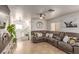 Comfortable living room showcasing a sectional sofa, tile flooring, and a decorative mirror for a cozy gathering space at 4786 Valleyside Ave, Las Vegas, NV 89115