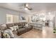 Open-concept living space featuring a sectional sofa seamlessly connected to the kitchen bar with seating at 4786 Valleyside Ave, Las Vegas, NV 89115