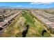 Aerial view of a golf course community with single-Gathering homes in a desert landscape at 4790 Toscana Pl, Pahrump, NV 89061