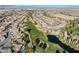 Overhead view showcasing a golf course community with scenic lake and lush green landscape at 4790 Toscana Pl, Pahrump, NV 89061