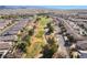 Stunning aerial view of community featuring a golf course surrounded by lush landscaping and mountain views at 4790 Toscana Pl, Pahrump, NV 89061