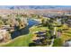 Expansive golf course community featuring a scenic lake surrounded by trees, set against a mountain backdrop at 4790 Toscana Pl, Pahrump, NV 89061