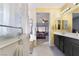 Bathroom view of a double vanity, walk-in shower, and bedroom beyond at 4790 Toscana Pl, Pahrump, NV 89061