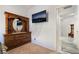 Bedroom with TV, dresser and view of the hallway at 4790 Toscana Pl, Pahrump, NV 89061