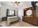 Cozy bedroom with natural light, a comfortable bed, and classic wood furniture at 4790 Toscana Pl, Pahrump, NV 89061