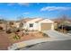 Single story home with desert landscaping, attached garage, and driveway at 4790 Toscana Pl, Pahrump, NV 89061