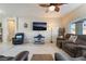 Cozy living room area with comfortable seating, a ceiling fan, and bright windows at 4790 Toscana Pl, Pahrump, NV 89061