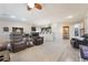 Open-concept living area showcasing tile floors, a ceiling fan, and seamless flow to the kitchen at 4790 Toscana Pl, Pahrump, NV 89061