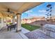 Covered patio with outdoor seating, ceiling fans, and views of the landscaped backyard at 4790 Toscana Pl, Pahrump, NV 89061