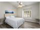 Bright bedroom featuring wood-look floors, a ceiling fan, and a window with natural light at 4980 Black Bear Rd # 104, Las Vegas, NV 89149