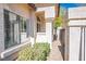 Close-up of an exterior wall with windows and a landscaped walkway at 4980 Black Bear Rd # 104, Las Vegas, NV 89149