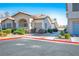 Inviting one-story home featuring desert landscaping, an arched entryway, and neutral paint colors at 4980 Black Bear Rd # 104, Las Vegas, NV 89149