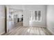 Sunlit living room featuring wood-look floors and views into the kitchen at 4980 Black Bear Rd # 104, Las Vegas, NV 89149