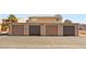 Image features a four-car garage with a concrete driveway and visible unit numbers at 5166 Gray Ln # L, Las Vegas, NV 89119