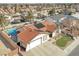 An aerial view of a single-Gathering home with solar panels, a pool, and lush landscaping in a residential area at 5200 Valley Glen St, Las Vegas, NV 89119