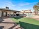 This backyard features an outdoor seating area, manicured artificial turf, and a refreshing in-ground pool at 5200 Valley Glen St, Las Vegas, NV 89119