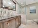 Beautiful bathroom with a dark wood cabinet, glass shower door, and stunning shower details at 5200 Valley Glen St, Las Vegas, NV 89119