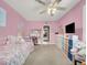 A pink bedroom features a bed, a desk, and a TV on the wall at 5200 Valley Glen St, Las Vegas, NV 89119