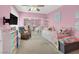 A pink bedroom features a bed, a desk, and a TV on the wall at 5200 Valley Glen St, Las Vegas, NV 89119