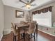 Cozy dining area with a wooden table, four chairs, and a ceiling fan at 5200 Valley Glen St, Las Vegas, NV 89119