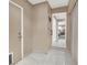 Hallway with tile flooring and beige walls looking into a bedroom with carpet at 5200 Valley Glen St, Las Vegas, NV 89119