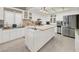 Bright kitchen with white cabinets, tile backsplash, stainless steel appliances, and a center island at 5200 Valley Glen St, Las Vegas, NV 89119