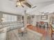 Open-concept living room and dining area with vaulted ceiling, wood floors and comfortable seating at 5200 Valley Glen St, Las Vegas, NV 89119