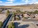 Gorgeous aerial view of a desert home with a spacious yard and mountain views in the distance, perfect for outdoor living at 5698 Hoptree Dr # 1, Pahrump, NV 89061