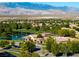 The community clubhouse features a pool, a lake and lush trees with mountains in the distance at 5698 Hoptree Dr # 1, Pahrump, NV 89061