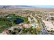 Aerial view of community, lake, golf course, pool, and mountains in the background at 5698 Hoptree Dr # 1, Pahrump, NV 89061