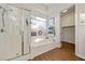 Bathroom with glass shower and soaking tub with natural light from the window at 5698 Hoptree Dr # 1, Pahrump, NV 89061