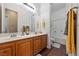 Bright bathroom featuring dual sinks and vanity with a shower-tub combination at 5698 Hoptree Dr # 1, Pahrump, NV 89061