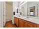 Bright bathroom features a double sink vanity with wood cabinets and large mirror at 5698 Hoptree Dr # 1, Pahrump, NV 89061