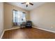 Bedroom showcasing neutral walls, one window, wood floors, and comfortable recliner at 5698 Hoptree Dr # 1, Pahrump, NV 89061