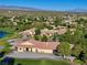 Expansive clubhouse with a red tile roof amidst lush greenery and mountain views at 5698 Hoptree Dr # 1, Pahrump, NV 89061